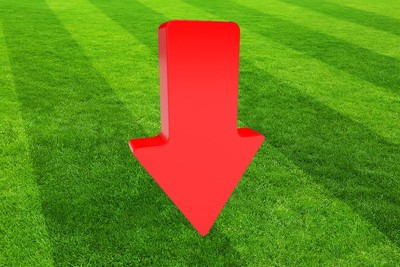 Red 3D Down Arrow Against Striped Football Stadium Grass