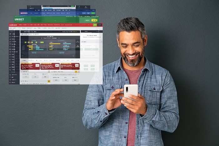 Smiling Man Holding Phone Against Grey Background with Betting Screenshots